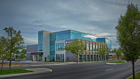 Modern office building with large glass windows and contemporary architecture.