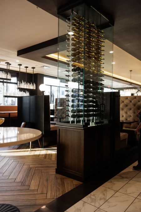Wine display stands elegantly in a modern restaurant interior.