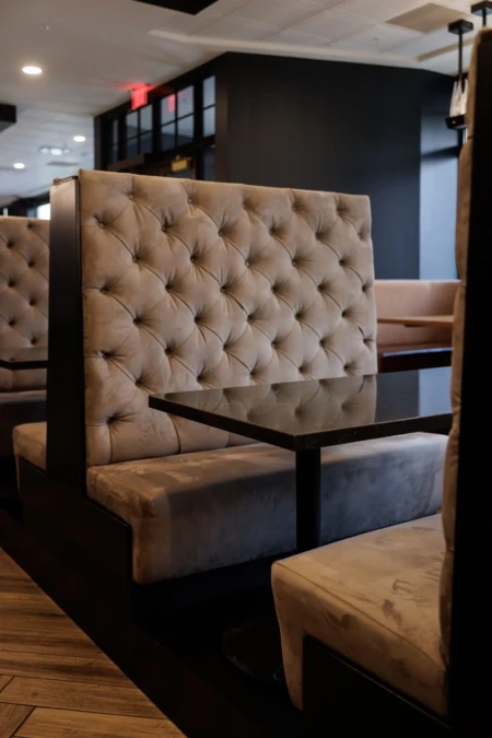 Plush booth seating with a sleek black table.