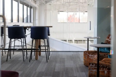 Stylish seating area with modern chairs and small tables.