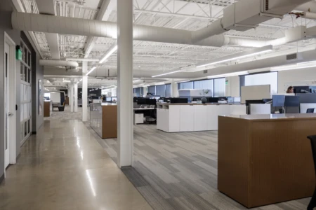 Spacious, contemporary office with desks and large windows.